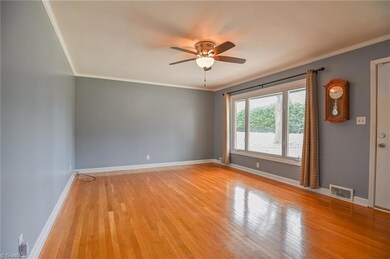 Den with large picture window and beautiful hardwood floors