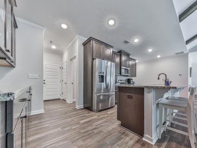 Kitchen featuring stainless steel appliances, crow