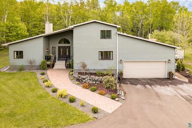 View of front of house with a front lawn and a gar