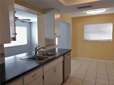 Kitchen has pass thru window/breakfast bar to Flor