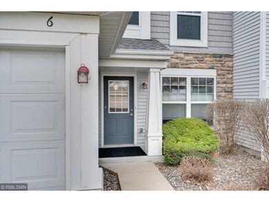 Front entrance is welcoming with pretty landscapin