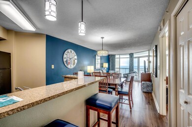 Kitchen featuring dark wood-style floors, a textur