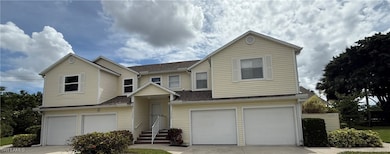 Traditional-style house with roof with shingles, a garage, and driveway