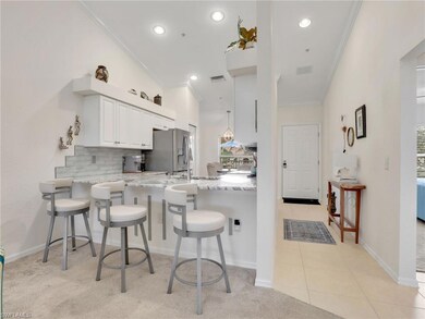 Kitchen featuring white cabinets, crown molding, l