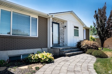 Doorway to property featuring brick siding