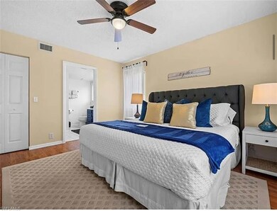 Bedroom with visible vents, a textured ceiling, wo