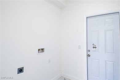 Washroom featuring electric dryer hookup and washe