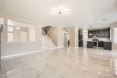 Unfurnished living room featuring baseboards, stai