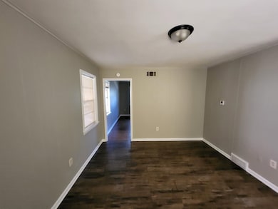 Spare room featuring dark hardwood / wood-style flooring