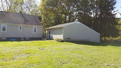 Backyard view and rear view of home and garage.