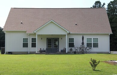 Back of property featuring a lawn and french doors