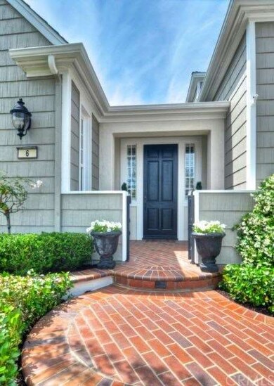 Charming brick entry with iron gate.