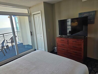 Bedroom with access to exterior, a textured ceilin