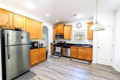 Kitchen with arched walkways, stainless steel appl