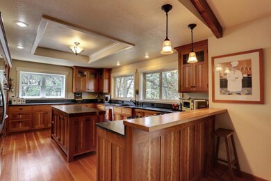Stylish Gourmet kitchen with center island opens t