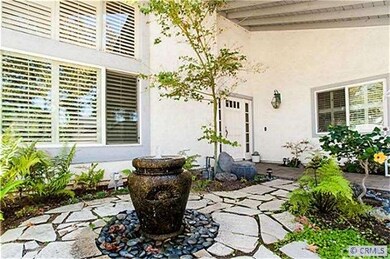 Gated front entry courtyard with ?zen-like? founta