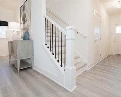 Staircase featuring wood finished floors and baseboards
