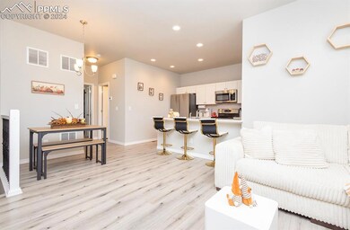 Living room featuring sink and light hardwood / wo
