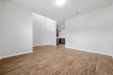 Unfurnished living room with light wood-style flo