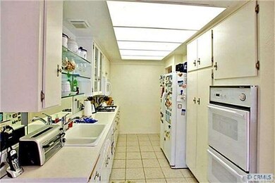Galley style kitchen with double oven and views to