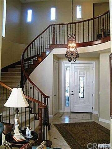 ocean view entry with wrought iron staircase banis