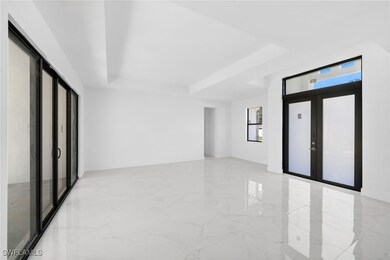 Unfurnished room with french doors and a tray ceil