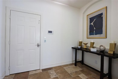 Entryway with stone tile floors and baseboards