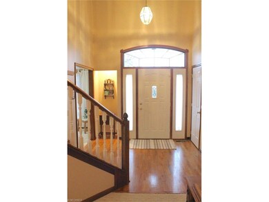 Wood front foyer boasts a lighted alcove, left.