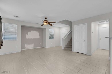 Unfurnished living room featuring ceiling fan