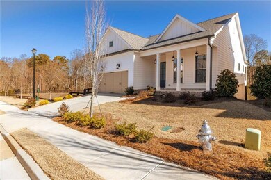 View of front of property with a porch and a garag