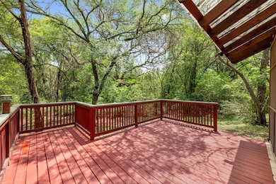 Wooden terrace featuring a forest view