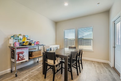 Dining space with light wood-type flooring and recessed lighting