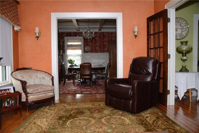 Living room with crown molding, double French door
