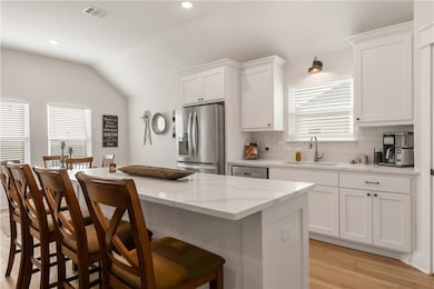 Kitchen with stainless steel appliances, a sink, l