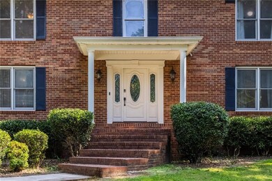Doorway to property featuring brick siding