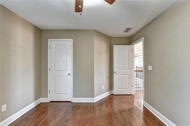 Unfurnished bedroom with baseboards, wood finished