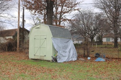 Handy storage building stays with the property.