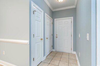 Doorway to outside with ornamental molding and lig