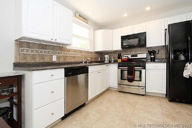 Beautiful updated kitchen with tile floors and bac