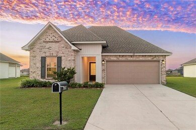 The well-manicured lawn and inviting entryway are