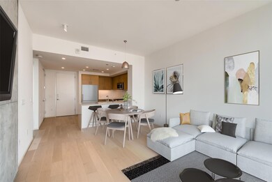 Living area featuring light wood-style floors, re