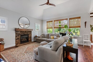 The hallway opens onto a spacious living room with soaring 15 ft ceilings!