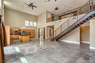 Living room with a high ceiling, baseboards, a cei