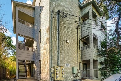 View of property exterior with brick siding, stai