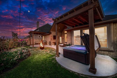Two matching pergolas on each side of the home were built to make this backyard oasis even more beautiful! The hot tub stays!