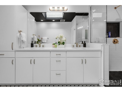 The primary bath features a generously sized vanity and storage cabinet.