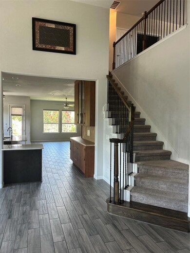 Stairs featuring a towering ceiling, a ceiling fa
