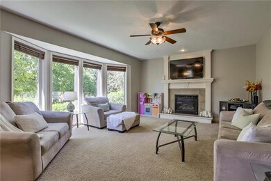 Great room with huge wall of windows overlooking p