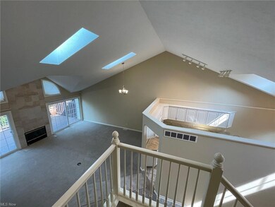 Spacious living room with fireplace and wall of wi