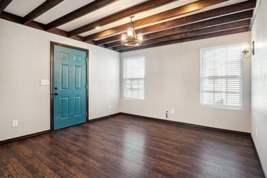 Foyer featuring beamed ceiling, dark wood-type flo
